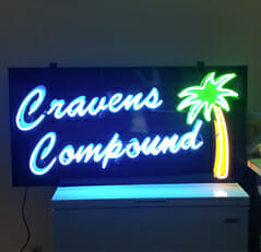 Cravens Compound neon sign with a palm tree on it made by mid state sign